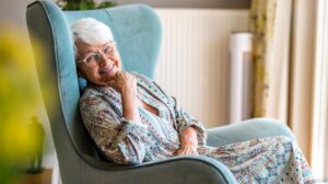 Senior woman relaxing in her wingback chair