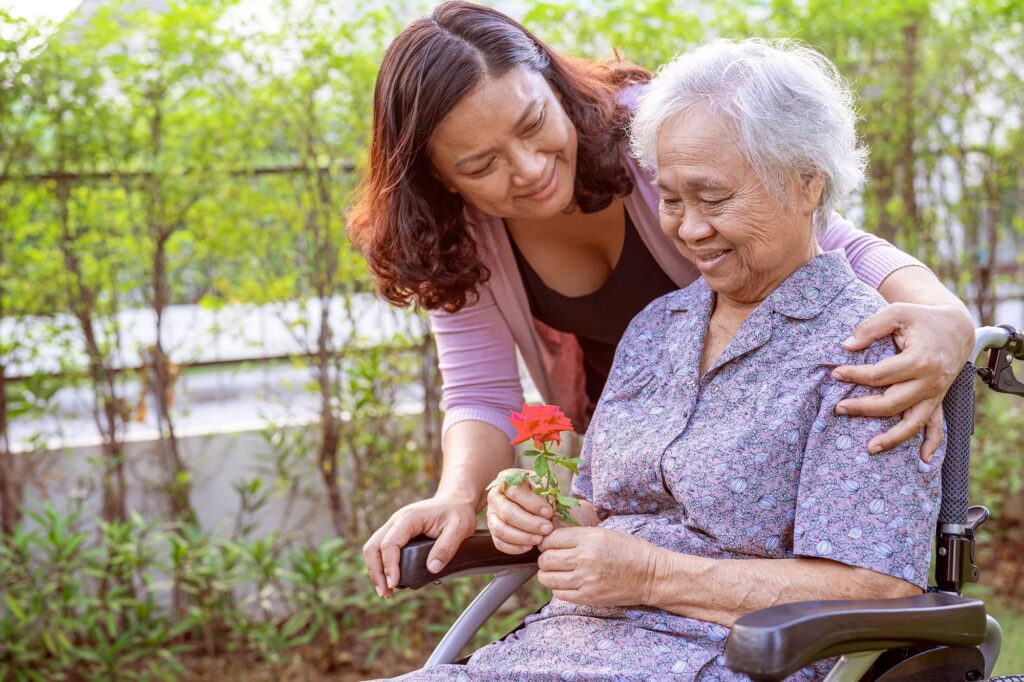 Senior woman with dementia and Daughter in the Garden