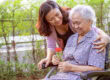 Senior woman with dementia and Daughter in the Garden