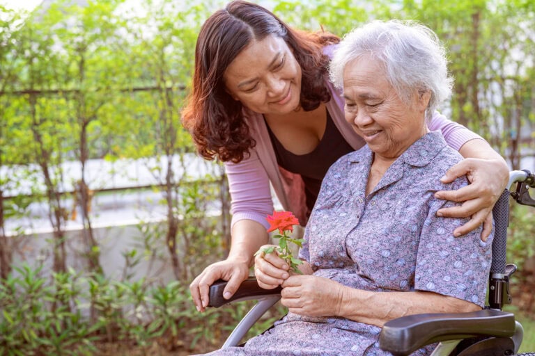 Senior woman with dementia and Daughter in the Garden