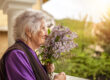 Senior woman with dementia smelling lilacs