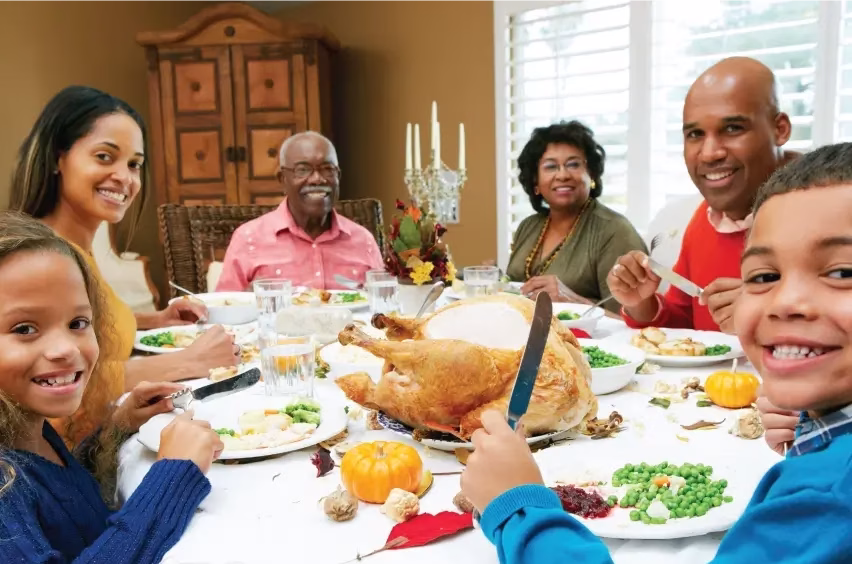 Grandparents, adult children, and grandchildren, enjoying a holiday dinner in the private dining room