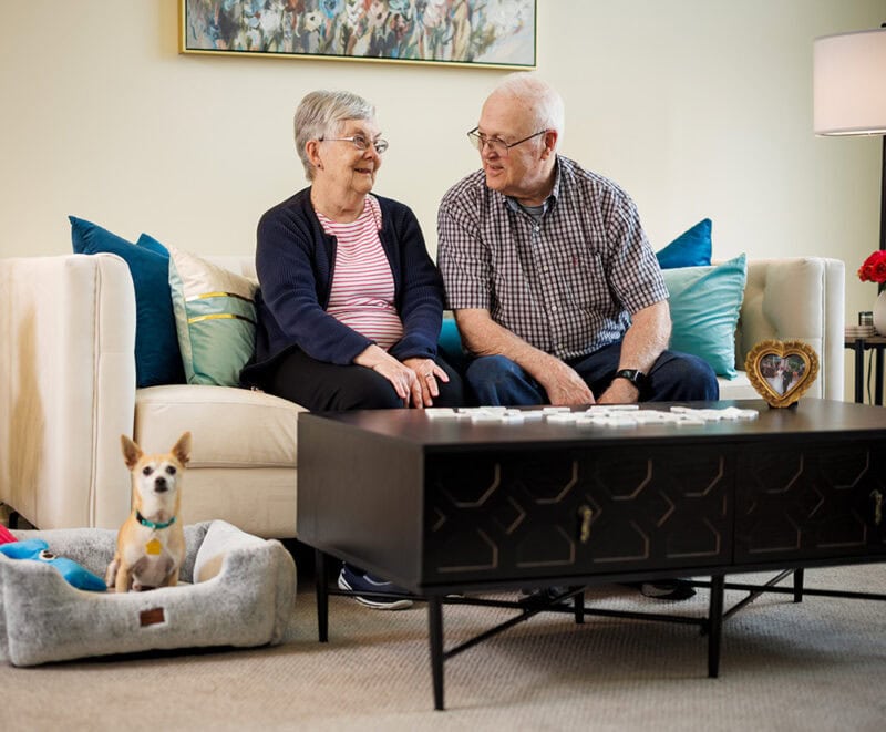 Couple with cute dog in the apartment.