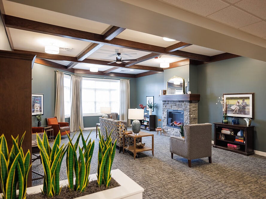 Gathering near the fireplace at The Courtyard at Delta Assisted Living