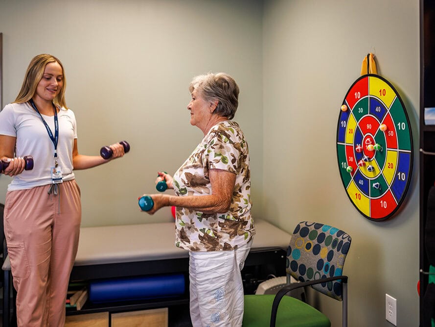 A female resident working with onsite physical therapy