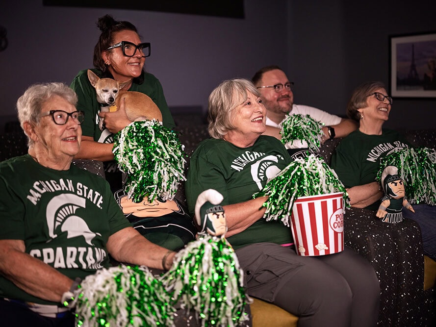 Residents and staff watching the Michigan Spartans Football Game